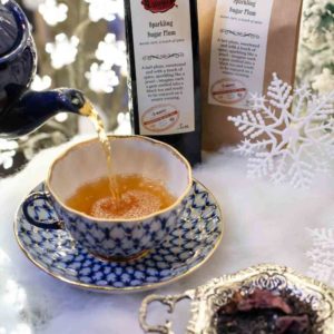 Online Tea Shop Loose Leaf Black Tea - Sparkling Sugar Plum Pouring in Teacup Tart Plum Winter