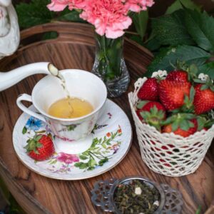 Online Tea Shop Loose Leave Oolongand Pouchong Tea - St. James Strawberry Oolong in a cup pouring tea