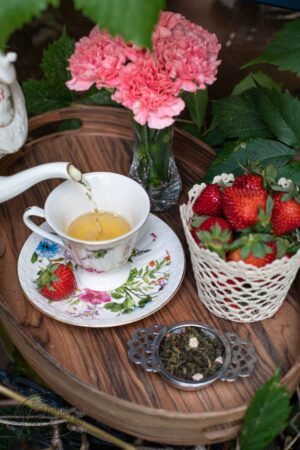 Online Tea Shop Loose Leave Oolongand Pouchong Tea - St. James Strawberry Oolong in a cup pouring tea