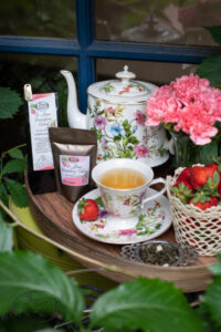 Online Tea Shop Loose Leave Oolongand Pouchong Tea - St. James Strawberry Oolong in a cup with strawberries